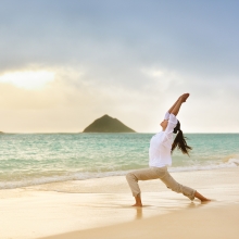 Woman doing yoga on the beach in Oahu