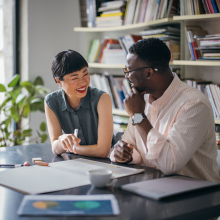 Two co-workers at work table