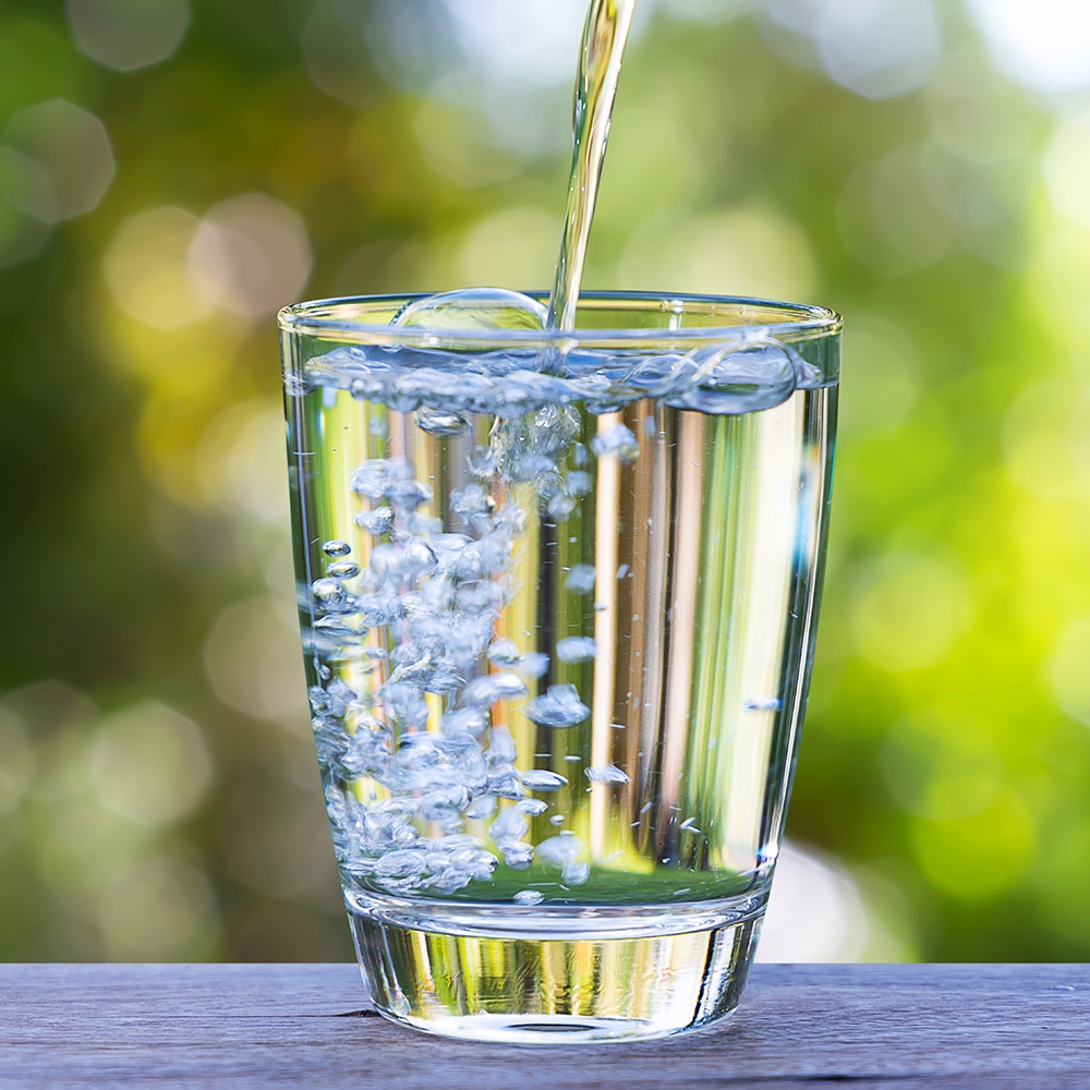 Refreshing, clear water being poured into a glass