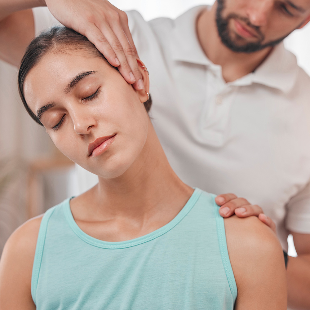 Woman getting adjustment at desk in office